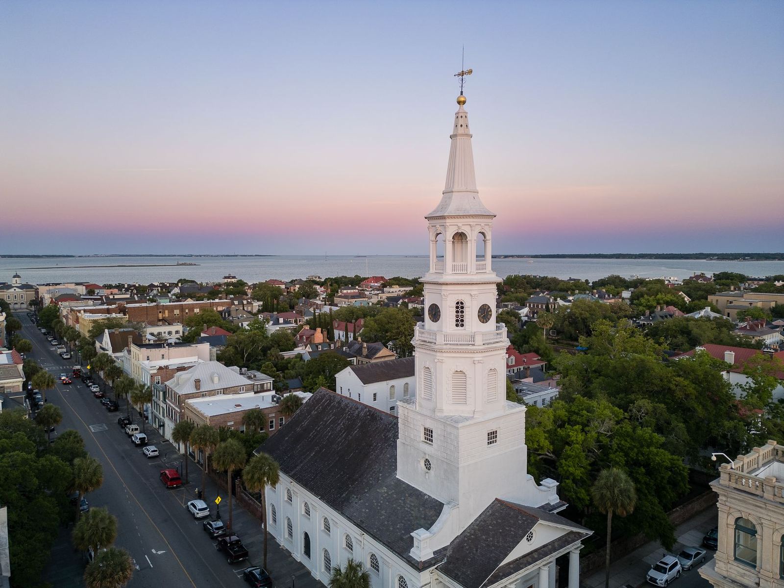 St. Michael's steeple at dusk with the Charleston harbor behind it