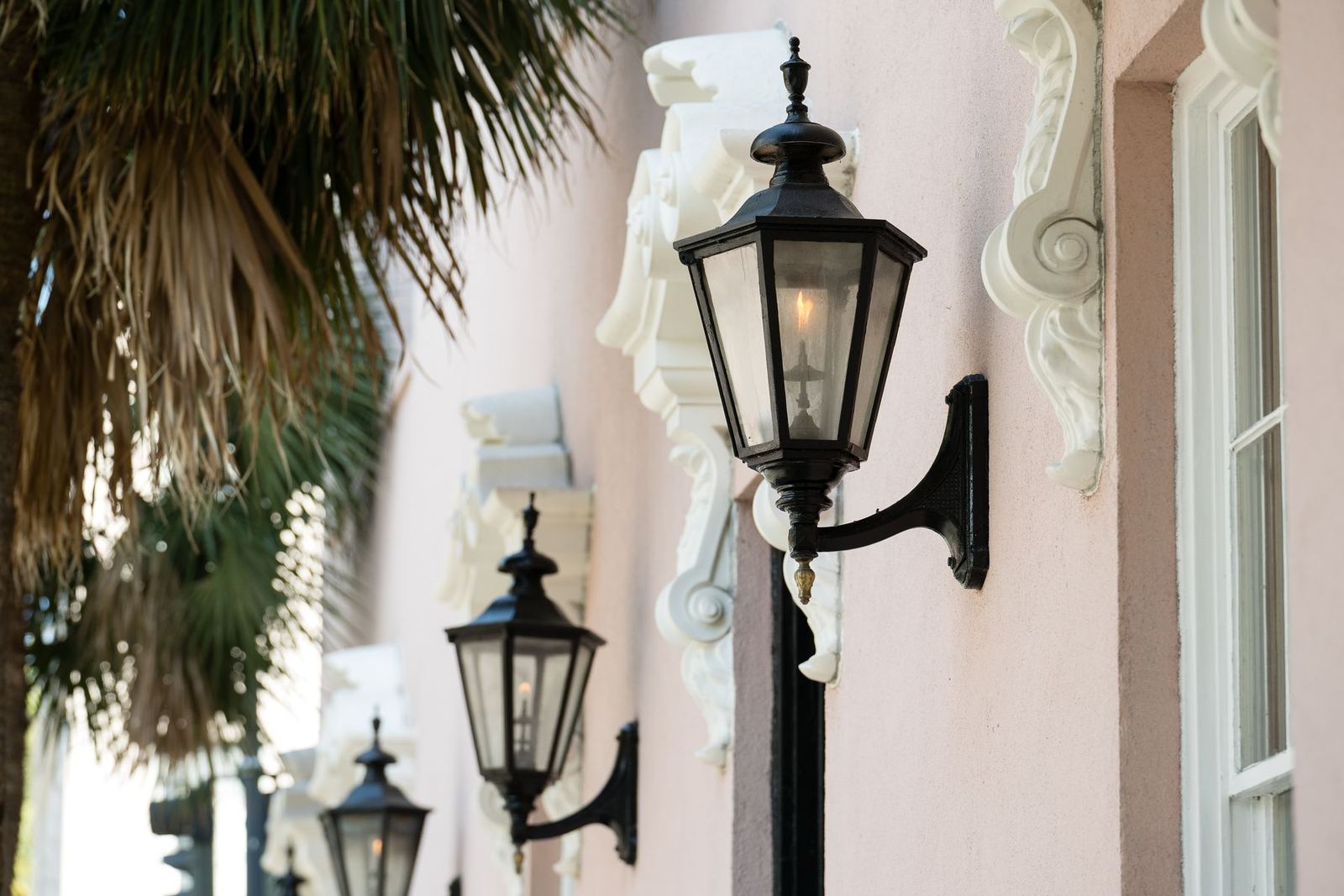 Black gas lanterns on a stucco wall