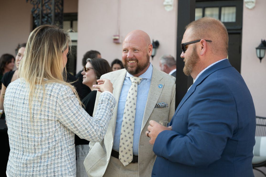 Attendees talking at a summit reception